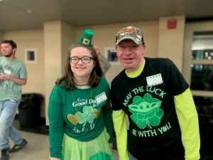 Picture of Male and Female both wearing shirts with shamrocks and "lucky" phrases
