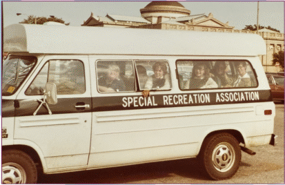 Special Recreation Association Bus with happy smiling kids in the windows from 50 years ago