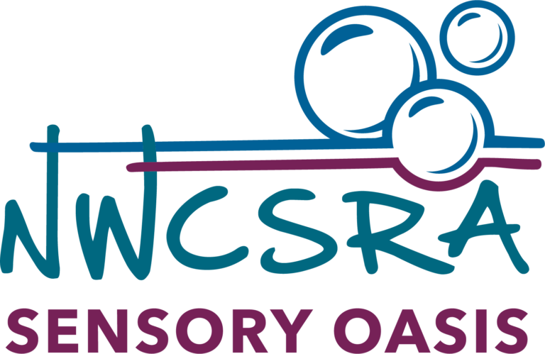 This logo is for the Sensory Oasis Room. "NWCSRA" is in the middle in blue, with "Sensory Oasis" right below it in purple. There are three bubbles just above the blue letters, with blue on top and purple on the bottom. Instead of the colors touching to complete the bubbles, both colors diverge and stretch outward.