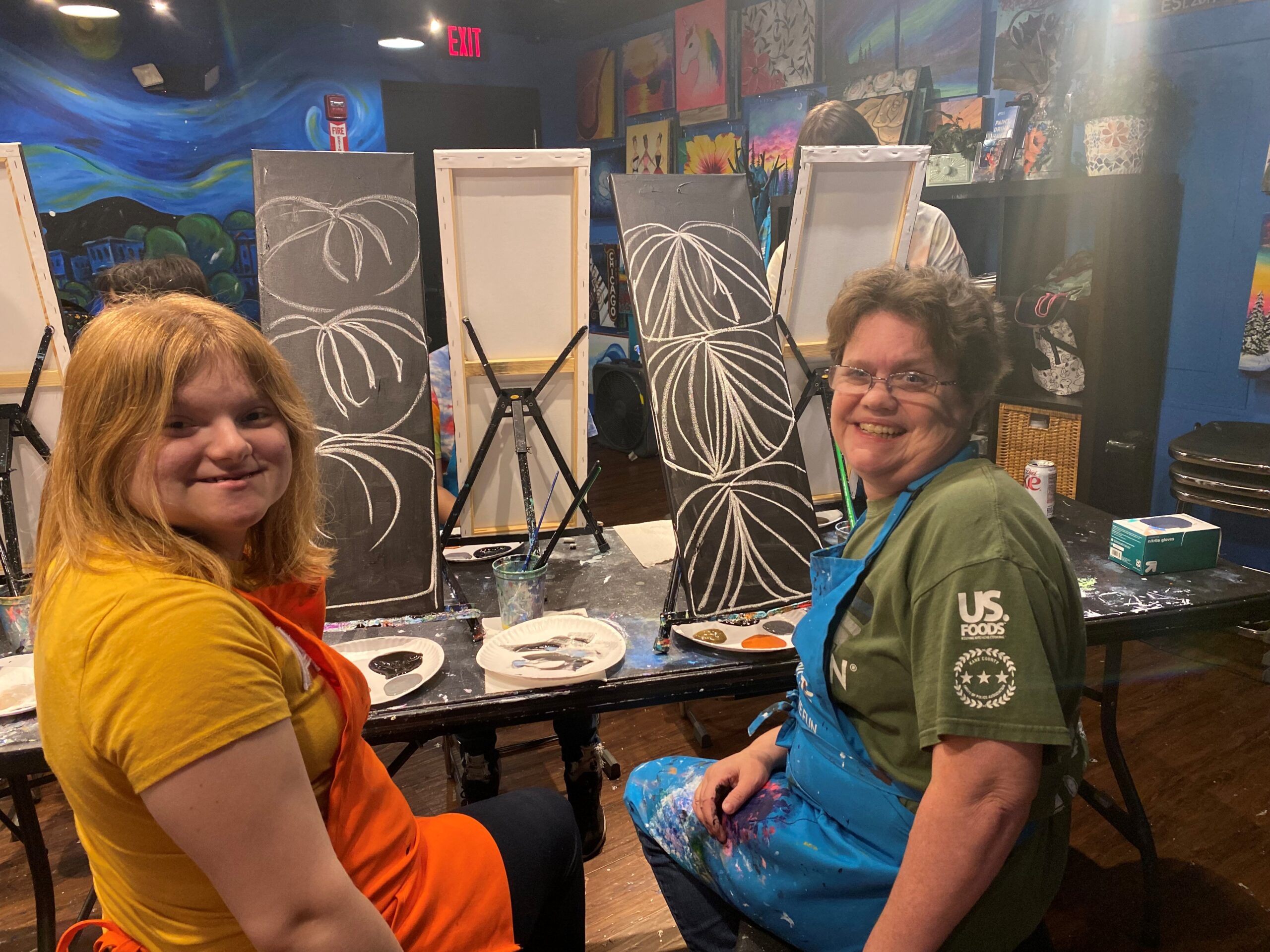 Two adult participants at a paint and sip program