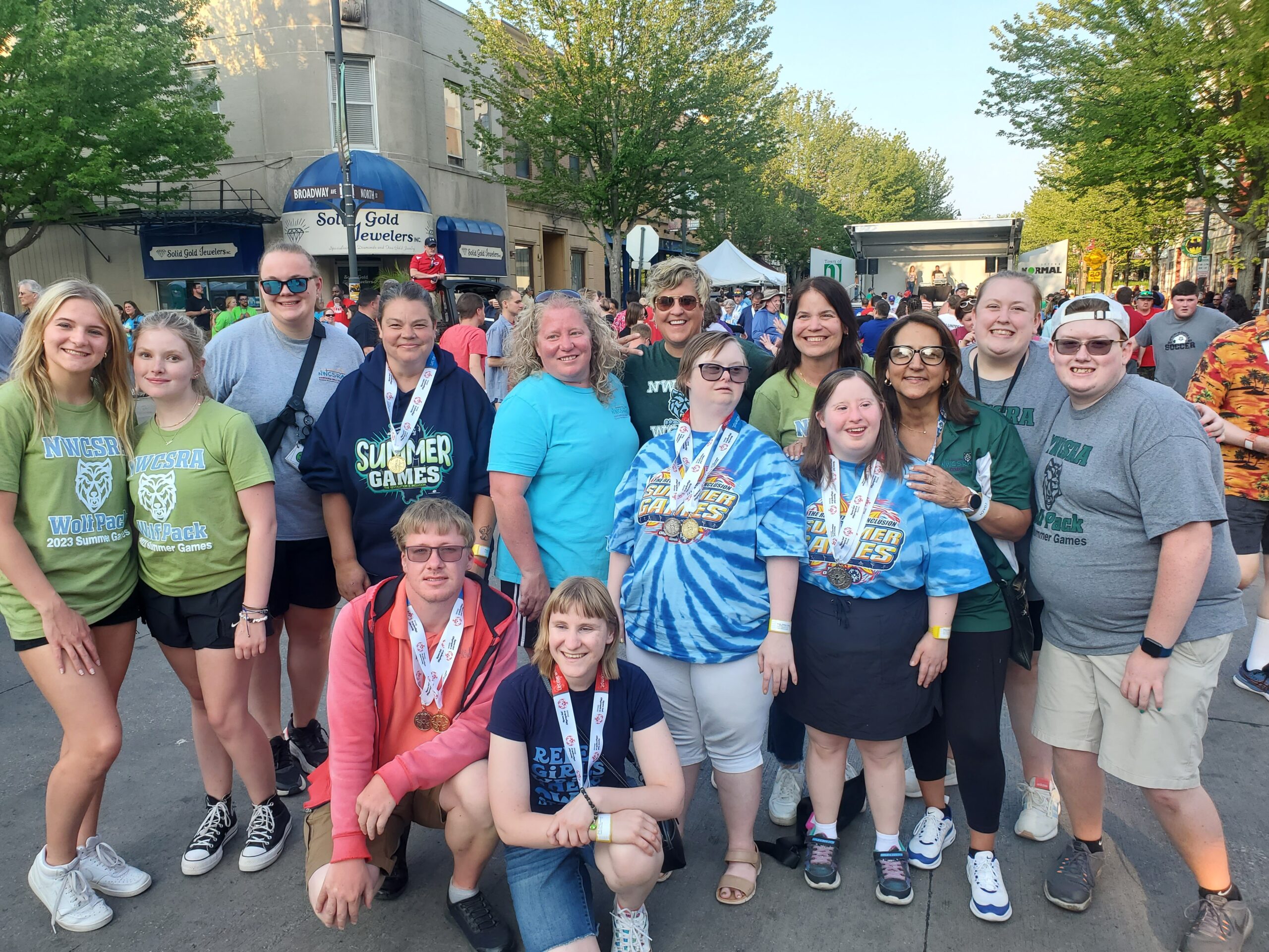 Group of participants posing in a city neighborhood at Wolf Pack summer games